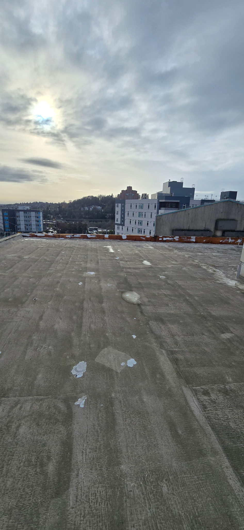Commercial building rooftop with overcast Puget Sound sky
