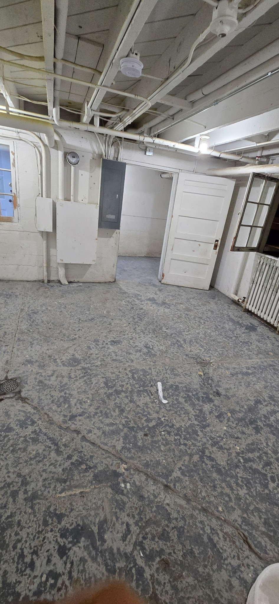 Basement with exposed pipes prepared for inspection