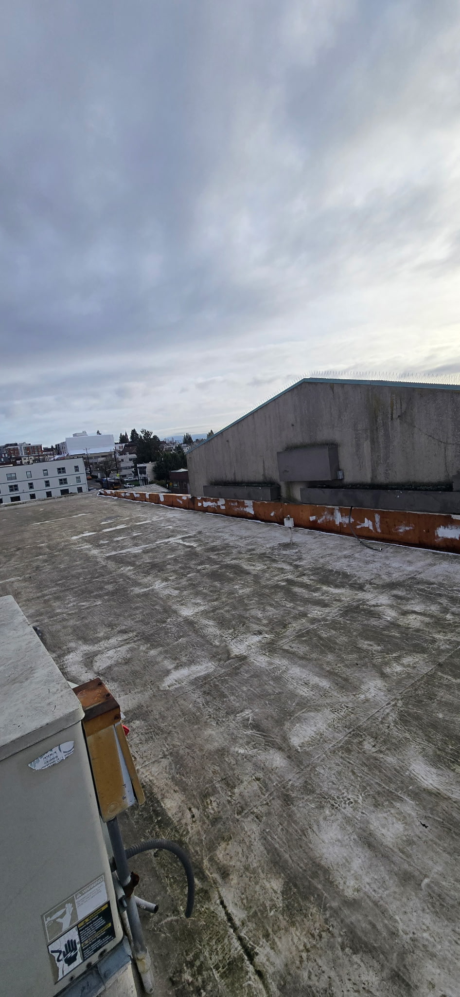 Commercial rooftop with Puget Sound skyline representing Seattle service area